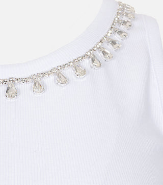 Close-up of white women top with crystals - CALIENTE