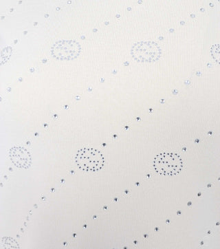 Close-up of White knitted blouse with crystals decoration - CALIENTE