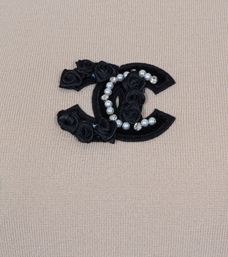 Detail of logo of Beige knitted short-sleeved blouse - Caliente Fashion